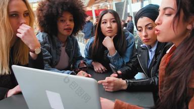 年轻的女性坐着集团听<strong>会</strong>说话的<strong>分享</strong>移动PC屏幕